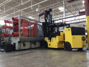 A large yellow forklift in a warehouse.