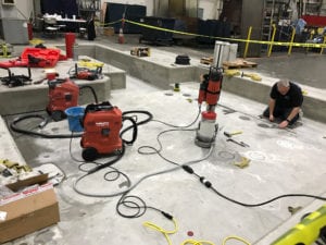 A man working on the floor of an office building.