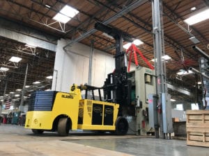 A yellow forklift in an industrial setting.