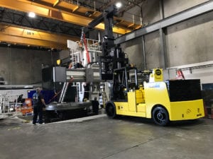 A large yellow forklift in a warehouse.