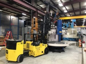 A forklift is parked in the middle of an industrial setting.