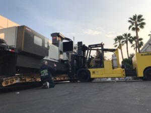 A man standing next to a large truck.