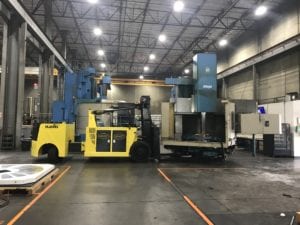 A large yellow forklift in an industrial setting.