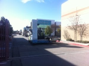 A truck driving down the street near buildings.