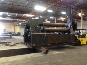 A large metal machine in a warehouse.