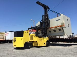 A yellow forklift is pulling a large white truck.