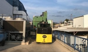 A yellow and black bus is parked on the side of the road