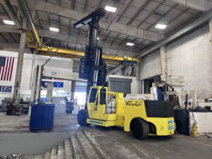 Yellow forklift in an industrial warehouse setting.