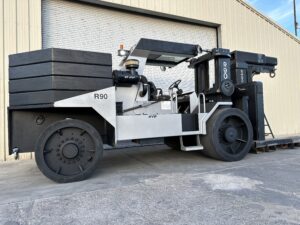 Large industrial forklift parked near warehouse.