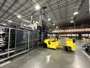 Warehouse with yellow forklift and machinery.