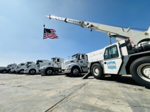 Tow trucks lined up with American flag.