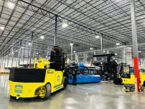 Warehouse interior with yellow industrial vehicles.