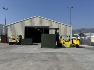 Warehouse with forklifts moving large crates.